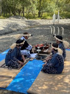 Young Ainu men performing the asircepnomi ceremony.
